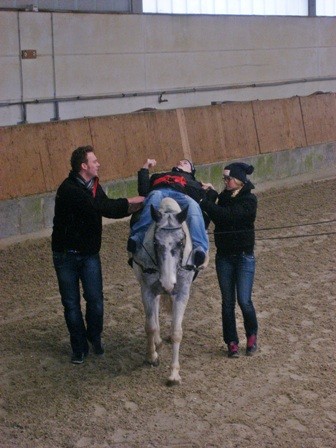 Daniel liegt auf dem Pferd Obsidian