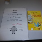 DINA4 Blatt mit Projektbeschreibung und Bild des Buches (vergrößerte Bildansicht wird geöffnet)
